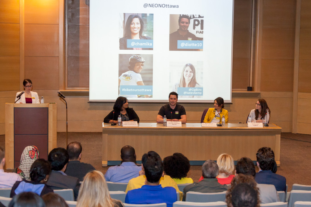 An audience watching a panel presentation