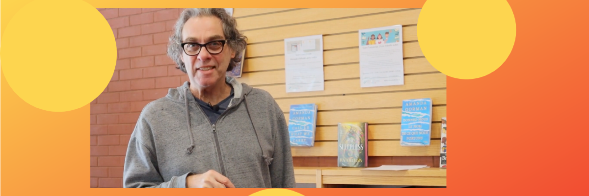 Librarian introducing pre-launch while standing in front of a wall of books
