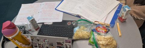 Photo of a table where two teenagers had their booknotes and crackers.