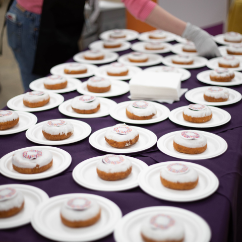 Table filled with branded donuts on plates
