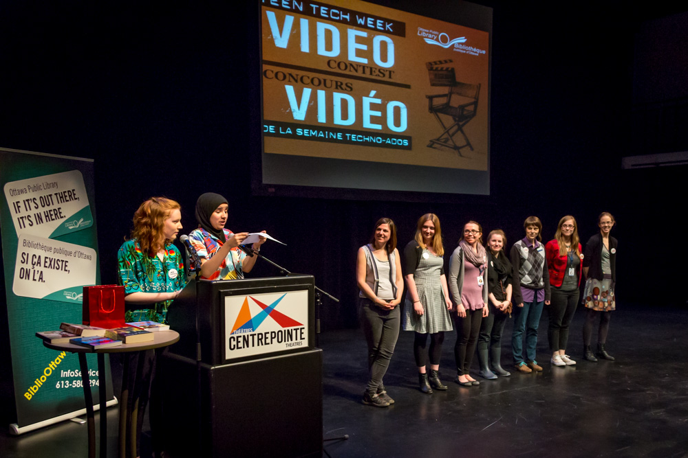 A group of teens receiving an award on stage.